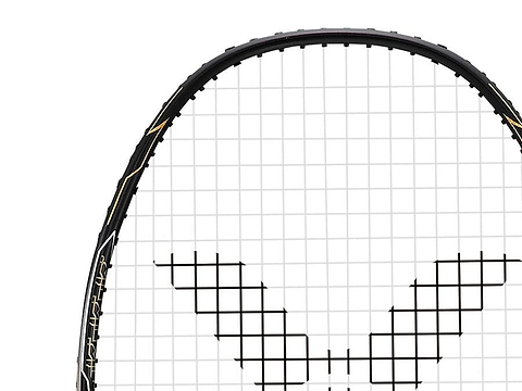 Close-up of a Victor Thruster F C badminton racket in a black and gold design on the strings. The top portion of the racket is visible, showcasing its sleek black frame and distinctive grid pattern, embodying the precision synonymous with Victor.