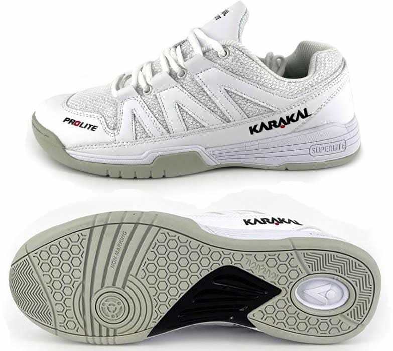 Introducing the Karakal KF Pro Lite Badminton Shoes in White, designed for lateral stability. The top shoe showcases the "Karakal" and "Prolite" brand logos on the side. The bottom shoe is equipped with a textured sole featuring a honeycomb pattern and circular design, offering enhanced comfort with its shock-absorbing gel insole.