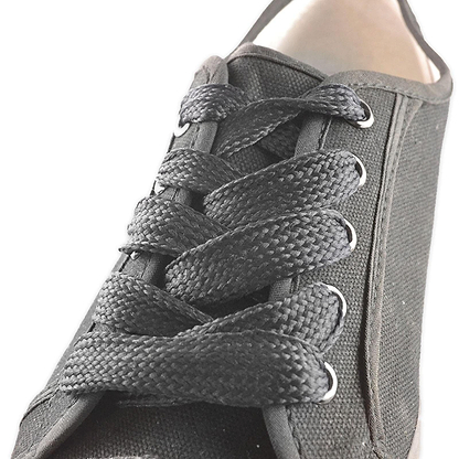 Close-up of a black canvas sneaker featuring Shoestring's Flat Block Badminton Shoe Laces in Black (140cm), highlighting the intricate lace pattern and the texture of the fabric.
