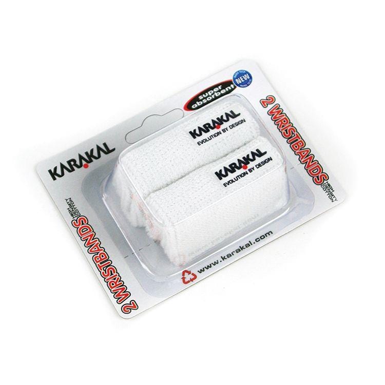 The Karakal Badminton Wrist Band (Twin Pack) - White comes with absorbent cotton wristbands arranged on a sleek card backing, which highlights the brand's website and the slogan "Evolution by Design." These white wristbands also feature an embroidered logo for enhanced style.