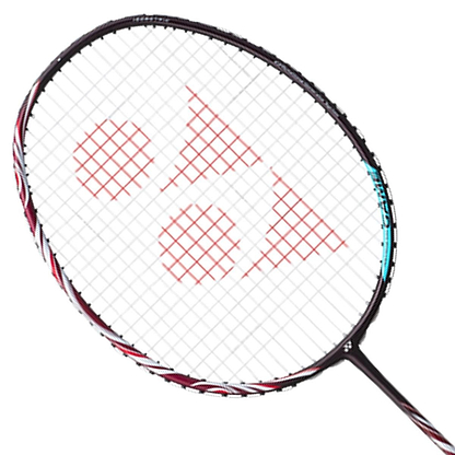 A close-up of a Yonex Astrox 100 Game 3U Kurenai badminton racket by Yonex highlights its striking black frame complemented by a red string pattern, emphasizing its head-heavy design ideal for powerful, steep attacks against a white background.