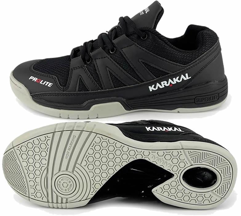A pair of Karakal KF Pro Lite Badminton Shoes in black, featuring white soles and displaying the brand "Karakal" on the side. These lace-up shoes are equipped with a shock-absorbing gel insole and provide lateral stability with a textured grip pattern on the bottom for enhanced traction.