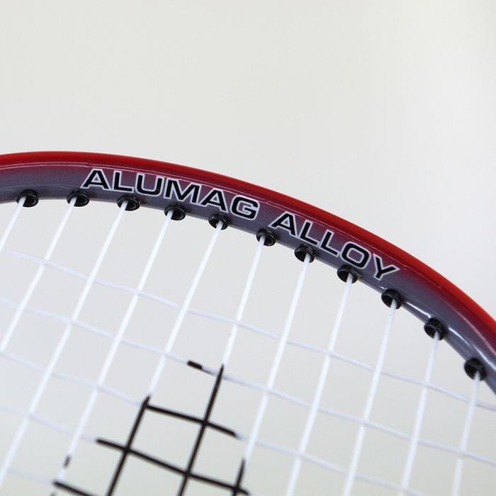 Close-up of the Karakal CB-2 Junior Badminton Racket's head featuring a red frame. The words "ALUMAG ALLOY" are printed on the aluminium head, and its strings create an isometric grid pattern.