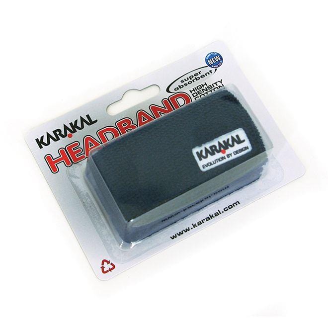 The Karakal Badminton Headband - Navy by Karakal is made from absorbent cotton and comes in clear plastic packaging with a cardboard back that showcases the embroidered logo. The package emphasizes its high absorbency and design, featuring a website URL and a recycling symbol.
