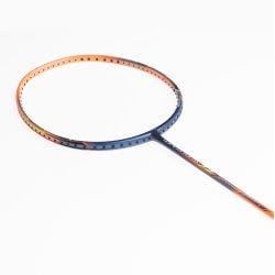 Close-up of the ultra-lightweight frame of the Li-Ning Windstorm 72 6U Badminton Racket - Orange, highlighting its circular shape. The gradient shifts from orange to black against a bright, overexposed background that accentuates its design.