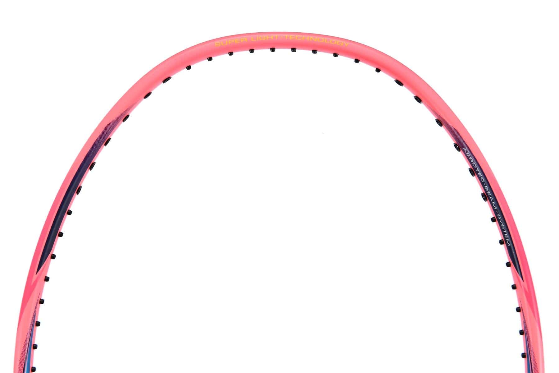 Close-up of a Li-Ning Windstorm 74 Badminton Racket frame featuring a pink and black design. The top portion displays its string holes and printed specifications. Its ultralight construction is characteristic of the Li-Ning Windstorm range, while the plain white background accentuates the frame's vibrant colors and details.
