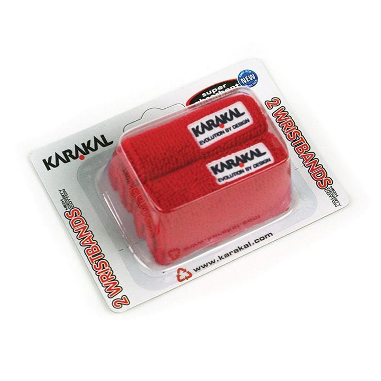 The packaging showcases the Karakal Badminton Wrist Band (Twin Pack) in red, featuring two super absorbent wristbands prominently displaying the Karakal logo. They are encased in clear plastic set against a white and red branded card. Ideal for badminton enthusiasts, these cotton wristbands seamlessly combine style and function.