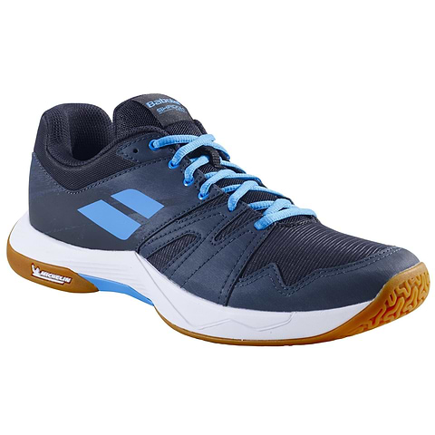The Babolat Shadow Team 2 Men's Badminton Shoes in Black/Grey feature a sporty low-cut design with branding on the side and tongue, light blue accents, a white midsole, and a durable gum-colored Michelin Rubber sole.