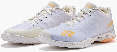 The Yonex Power Cushion Aerus Z2 Womens Badminton Shoes in white and orange feature the renowned Power Cushion for superior comfort, mesh uppers, and textured rubber soles—perfect for badminton enthusiasts.