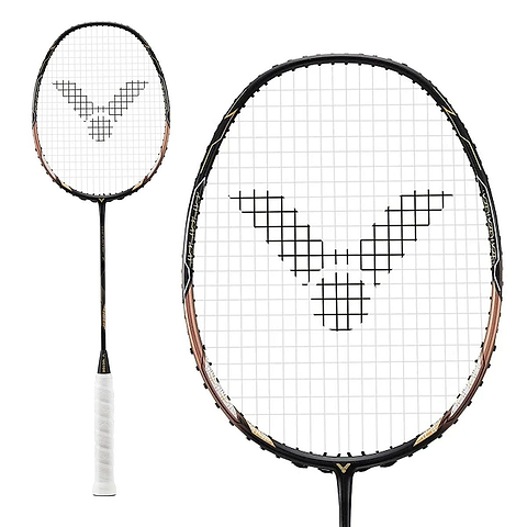 A close-up of the Victor Thruster F C Badminton Racket - Black Gold displays a unique grid pattern on the strings, housed within a sleek black and gold frame. The handle of this Victor racket is expertly wrapped in pristine white tape.