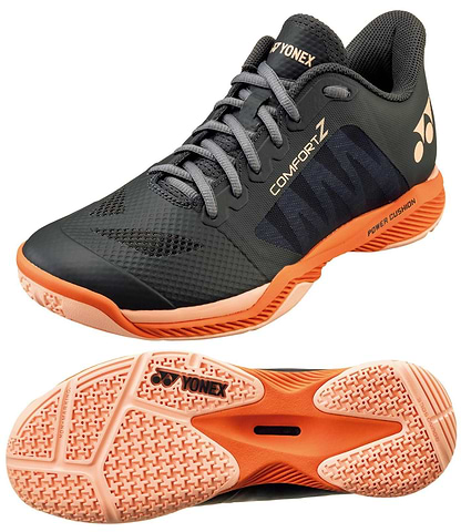 A pair of Yonex Power Cushion Comfort Z3 men's badminton shoes in dark grey, featuring mesh uppers, lace closures, Power Cushion technology, and patterned soles. One shoe is seen from the side and the other from the bottom.