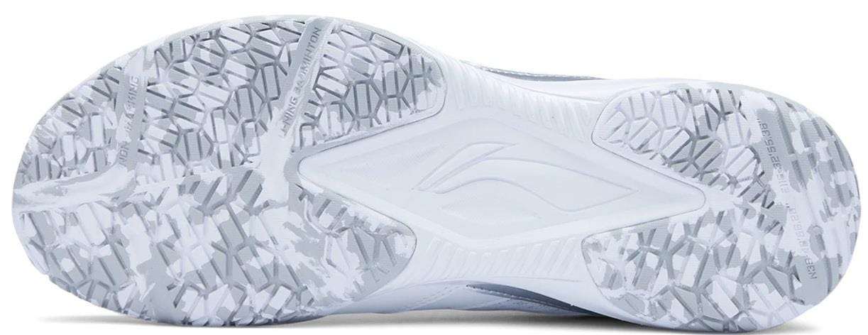 The image displays the white sole of the Li-Ning Blast JF-01 Lite Unisex Badminton Shoes, with an intricate geometric tread for excellent grip and traction on the court.