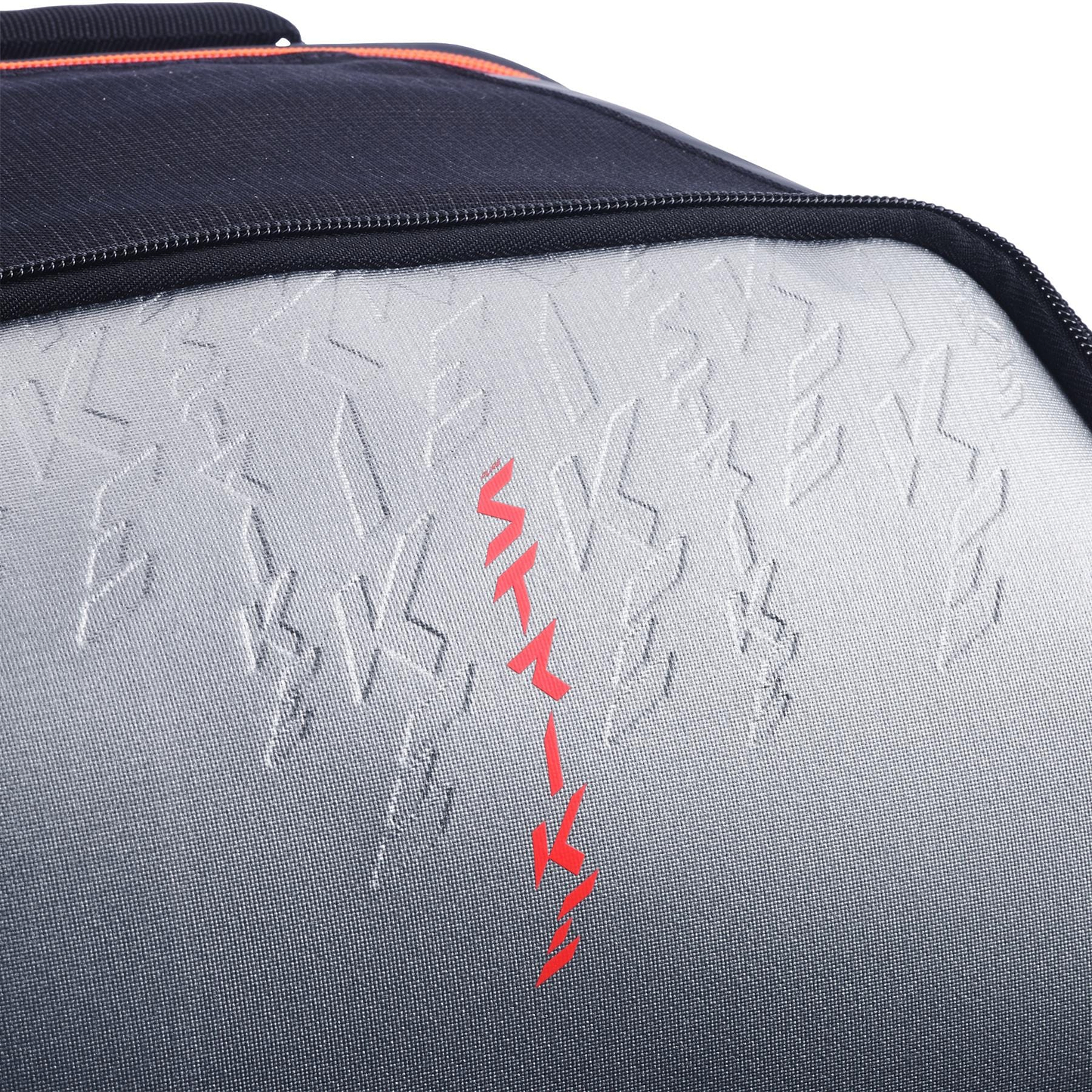 Close-up of the textured carbon grey surface with raised and bold red zigzag lines on the Babolat Pure Strike Tennis Backpack by Babolat.