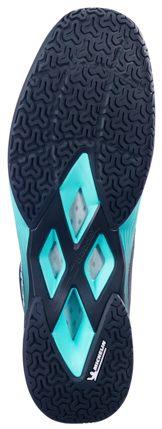 The image shows the sole of the Babolat Shadow Spirit 2 Mens Badminton Shoes in Black/Cyan, featuring a geometric Michelin tread, aqua blue accents, and mesh cutouts for breathability.