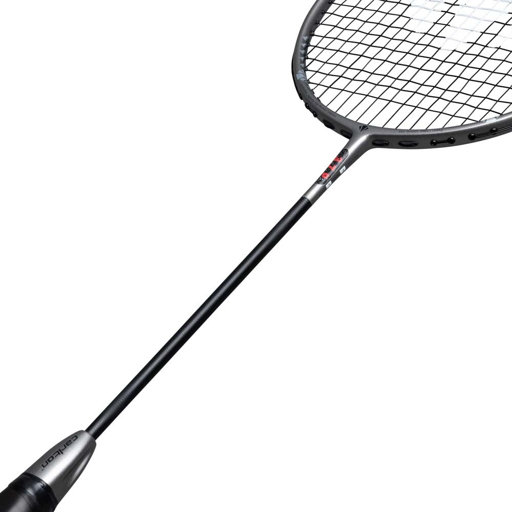 A close-up view of the Carlton 3.7P G6 4U Badminton Racket in grey, featuring a head-heavy balance and a grid string pattern, displayed diagonally on a white background.