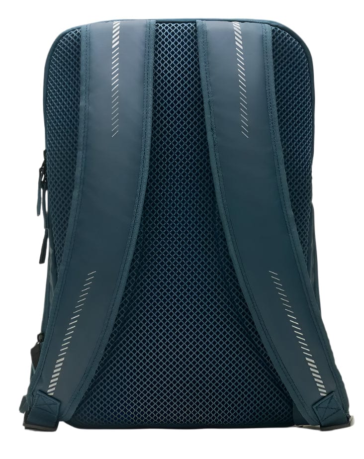 The image depicts the back of a Kanso Intuko Badminton 23L Backpack in navy with mesh padding and adjustable straps. The straps have reflective diagonal lines for visibility, and the backpack stands upright against a plain white background.