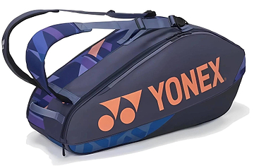 The Yonex 92426EX 6 Racket Pro Tennis Bag in Midnight Navy holds up to 6 rackets and features two shoulder straps for easy carrying, with a bold orange logo and geometric blue accents for a sporty look.