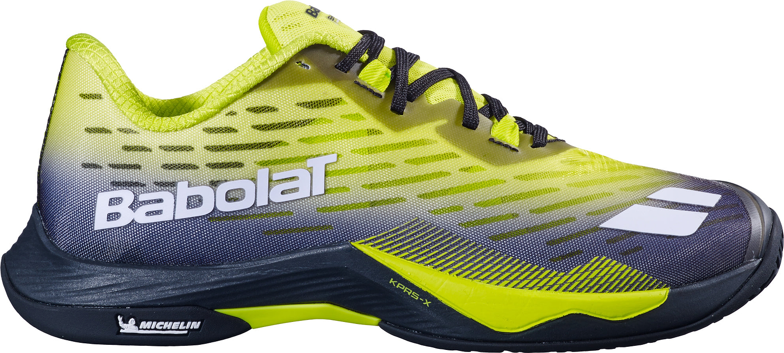 The Babolat Shadow Tour 5 Mens Badminton Shoes by Babolat feature a bold black and lime gradient design with black laces and a sharp white side logo. Designed as premium indoor court shoes, they include Michelin branding near the heel for superior grip and durability.