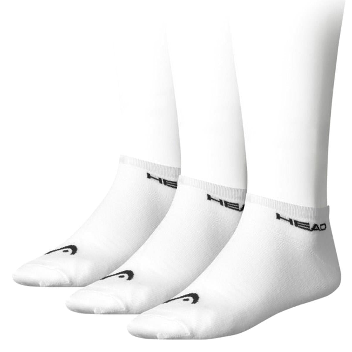 Displayed on white mannequin legs, three pairs of the HEAD Sneaker Badminton Socks in white feature a comfortable cotton blend with a black "HEAD" logo by the ankle and a small logo on the toe.