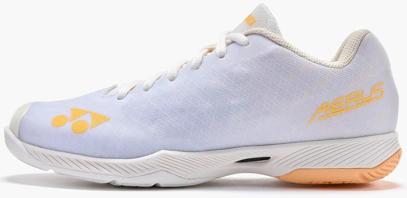 The Yonex Power Cushion Aerus Z2 Women's Badminton Shoes in white and orange feature a lace-up design, textured sole, "AERUS" branding, and logo on the side, plus light beige interior lining and heel for added comfort.