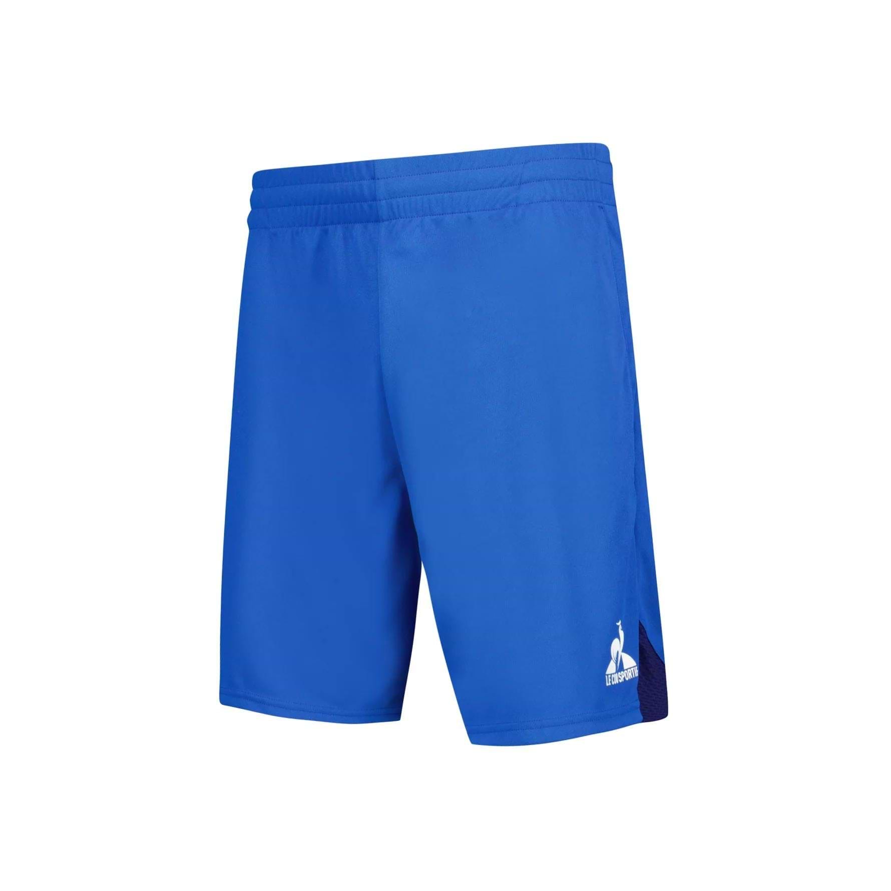 The Le Coq Sportif Pro Men's Badminton Shorts in Lapis Blue feature an elastic waistband, a subtle white logo on the left leg, and a dark blue side panel. Crafted from breathable material, they provide exceptional dryness with their smooth and lightweight fabric.