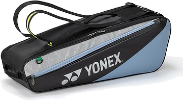 The Yonex BA52526EX Club 6 Racket Badminton Bag in black and blue features durable construction, a zippered pocket, shoulder strap, and the Yonex logo—ideal for carrying up to six rackets and your badminton gear.