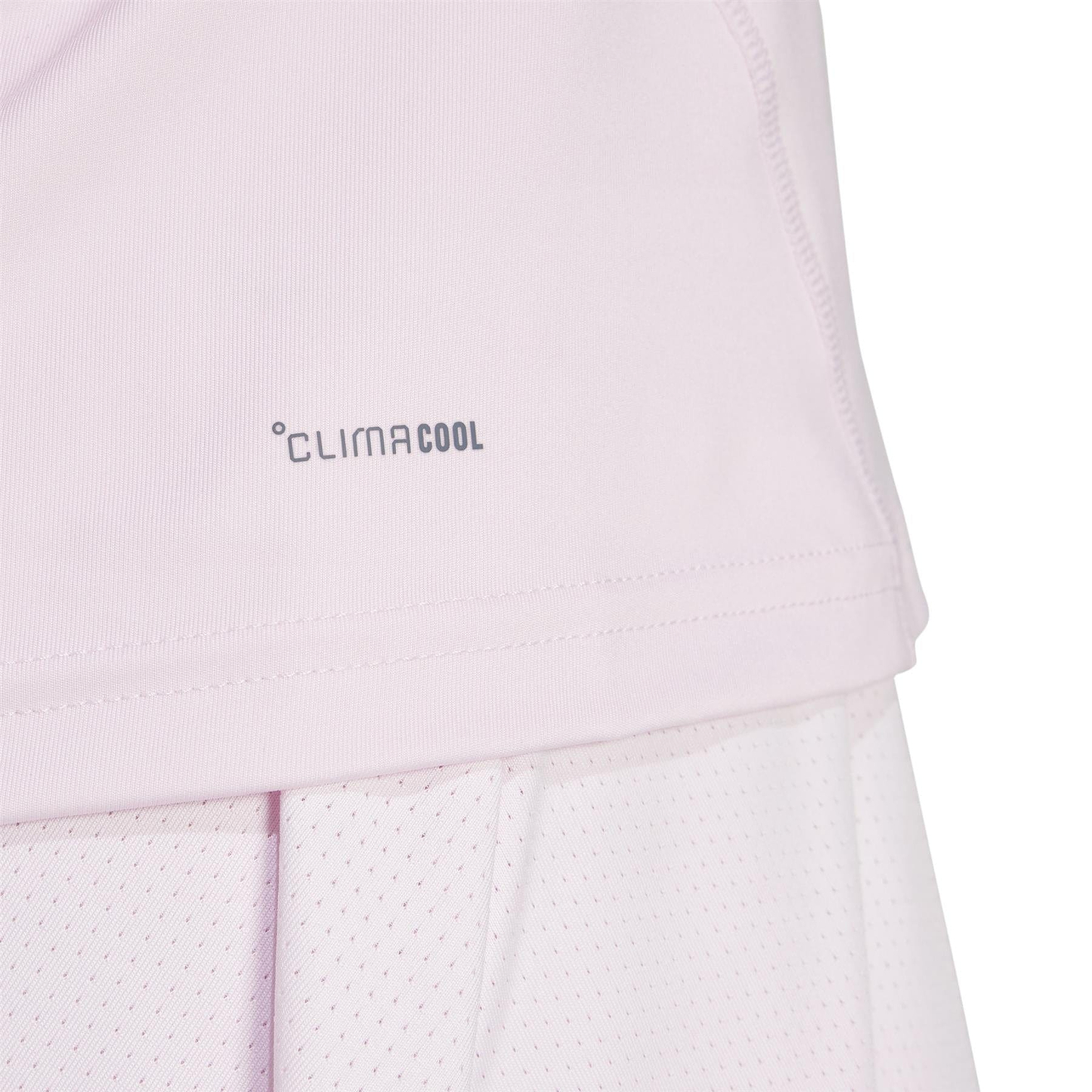 Close-up of a light pink adidas Women's Club Badminton Tank Top featuring the "CLIMACOOL" logo near the hem. Made from recycled materials, its breathable, lightweight fabric is ideal for sports or physical activities.