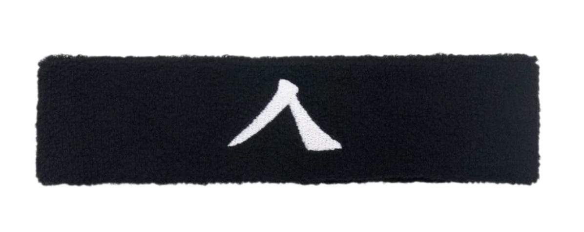 The Kanso 4cm Headband - Black, made from absorbent fabric, showcases a distinctive white triangular logo against its black design for ultimate comfort.