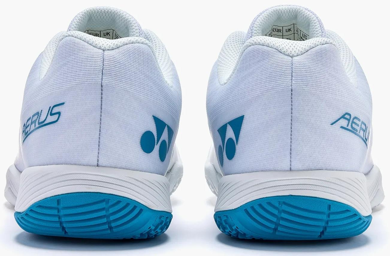 The Yonex Power Cushion Aerus Z2 Mens Badminton Shoes in white and blue feature blue soles, light blue logos, and "Aerus" on the heels—ideal for players seeking comfort from the Yonex Aerus Z2 line.