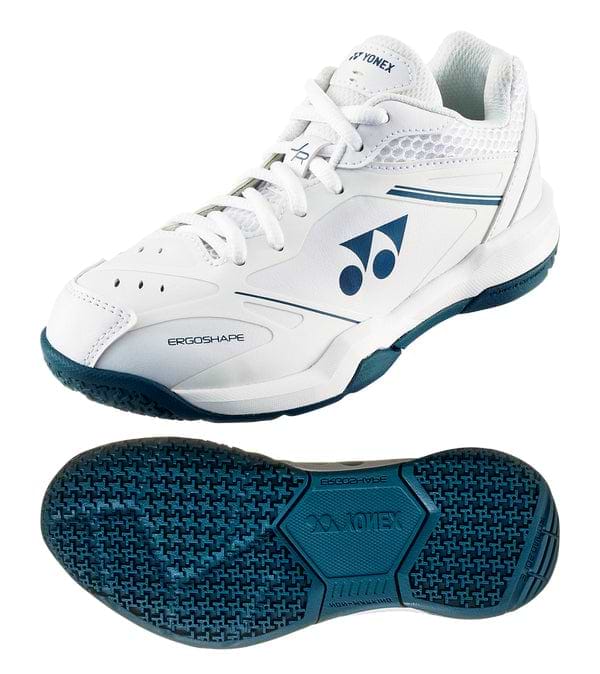 The Yonex Power Cushion 65 Junior Badminton Shoes in white feature dark teal accents, a textured sole for grip, Yonex's Power Cushion technology, and the signature logo and "ERGOSHAPE" text on the side for enhanced performance.