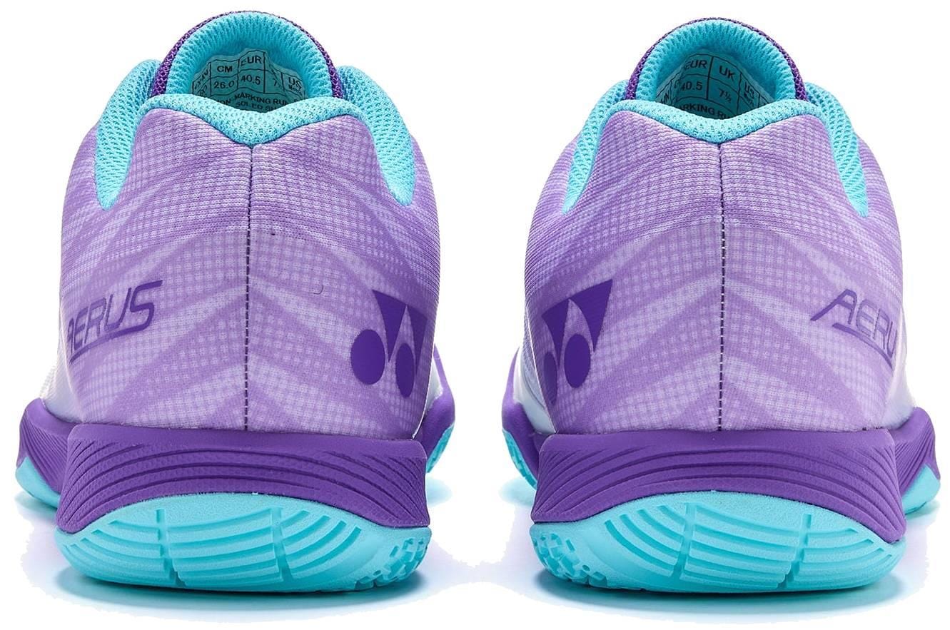 A pair of Yonex Power Cushion Aerus Z2 Wide Men's Badminton Shoes in indigo, shown from the back with geometric patterns, Yonex logos, and light blue soles.