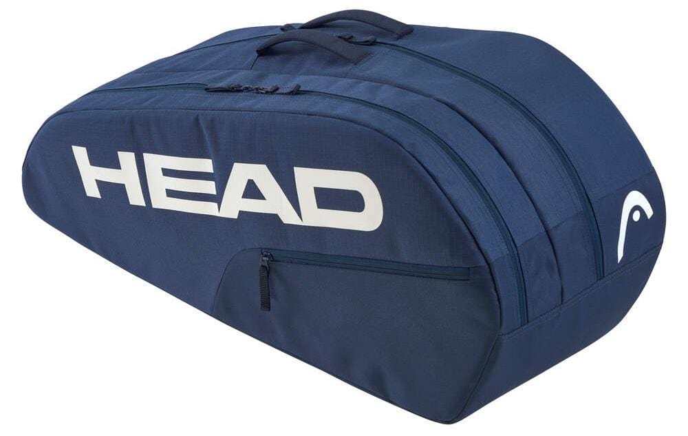 A blue HEAD BASE 6 Racket Badminton Bag M - NV, featuring the brand in large white letters, has a curved design with multiple compartments and zippers, reinforced for durability, a top handle, and holds up to six rackets.