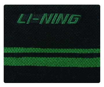 Close-up of the Li-Ning Logo Wristband in black with a breathable fabric design, featuring the brand's green logo embroidered at the top and two parallel horizontal green stripes. Ideal for badminton players seeking both style and comfort.