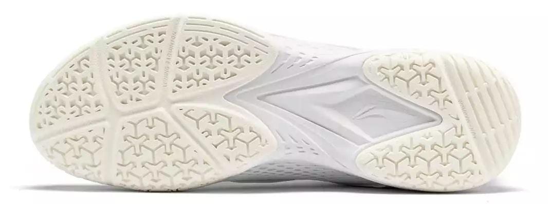 The image displays the white sole of Li-Ning Almighty V2.0 Unisex Badminton Shoes, featuring a textured grip with triangular and star-like patterns for enhanced comfort and traction on the court.