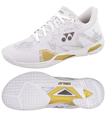 The Yonex Power Cushion Eclipsion Z3 Men's Badminton Shoes in white and gold feature a geometric upper design, textured grip sole with a central gold diamond for cushioning and repulsion, and the Yonex logo displayed on the tongue and side.