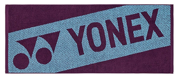 The Yonex AC1113EX Badminton Sports Towel - Bordeaux is a 100% cotton rectangular towel with a blue diagonal stripe, "YONEX," and the Yonex logo in dark purple on a contrasting purple background.