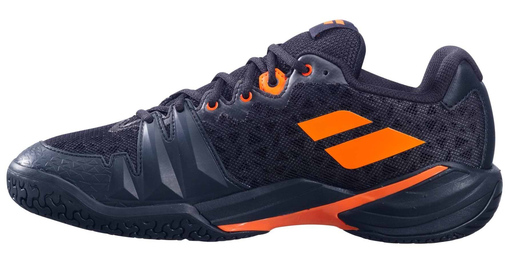 The Babolat Shadow 4 Men's Badminton Shoes in Black/Orange feature textured black material, orange accents, an orange side logo, a black outsole with detailed tread, and a bold orange-highlighted midsole.