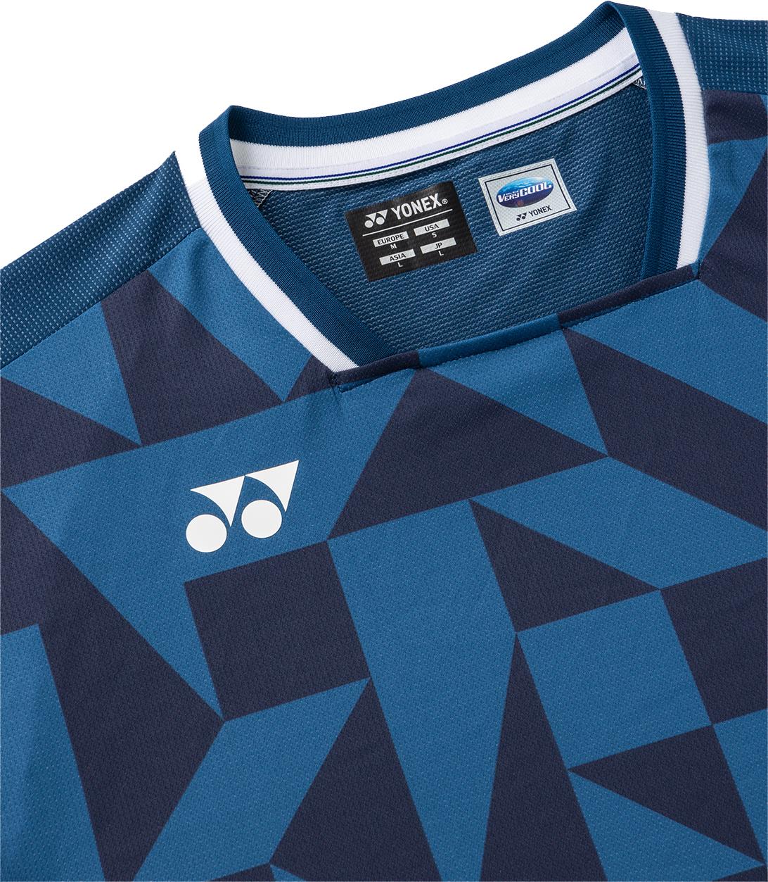 A close-up of the Yonex 10712YX Crew Neck Men's Badminton T-Shirt in Indigo Blue shows its geometric dark blue pattern, white Yonex logo on the chest, inner tags, and highlights its stylish and comfortable design.