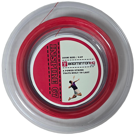 A clear round plastic reel holds BadmintonHQ Inspire 67 Zoom badminton string in strong red, featuring a 0.67mm gauge for power and durability. The label has a player silhouette and text: "200M Reel / 0.67," branded by BadmintonHQ.co.uk.