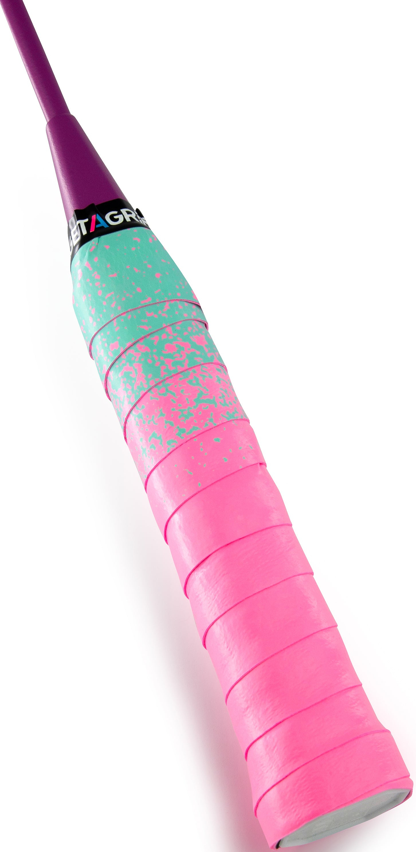 A close-up of the Get A Grip Paint the Lines Pink / Mint Badminton Racket Overgrip by Get A Grip, showing teal and pink grippy tape, a purple end cap, and a black label with “GRIP” partly visible near the handle’s top.