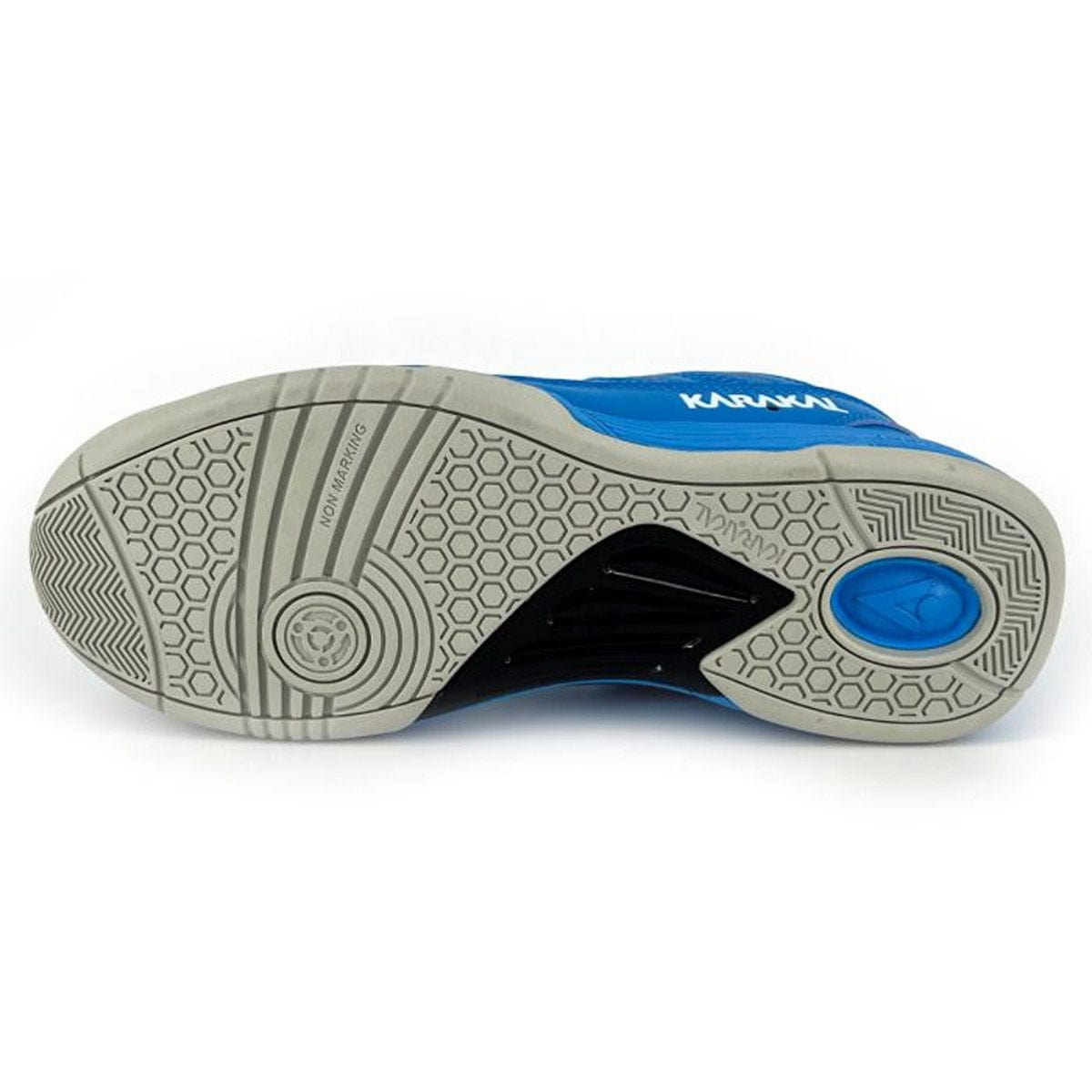 The image showcases the sole of a Karakal KF Pro Lite Badminton Shoe, characterized by a hexagonal tread pattern that promotes optimal lateral stability. This blue shoe features a predominantly gray sole accented with black and blue details, along with a circular blue logo positioned near the heel.