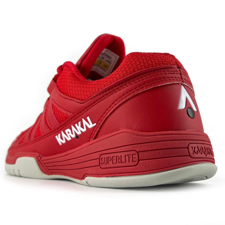Introducing the Karakal KF Pro Lite Badminton Shoes in New Red: These high-performance athletic shoes feature a textured sole, breathable mesh fabric, and a gel insole designed for shock absorption and enhanced comfort. The shoes offer lateral stability, with the heel displaying a white logo and embossed "SUPERLITE" branding.