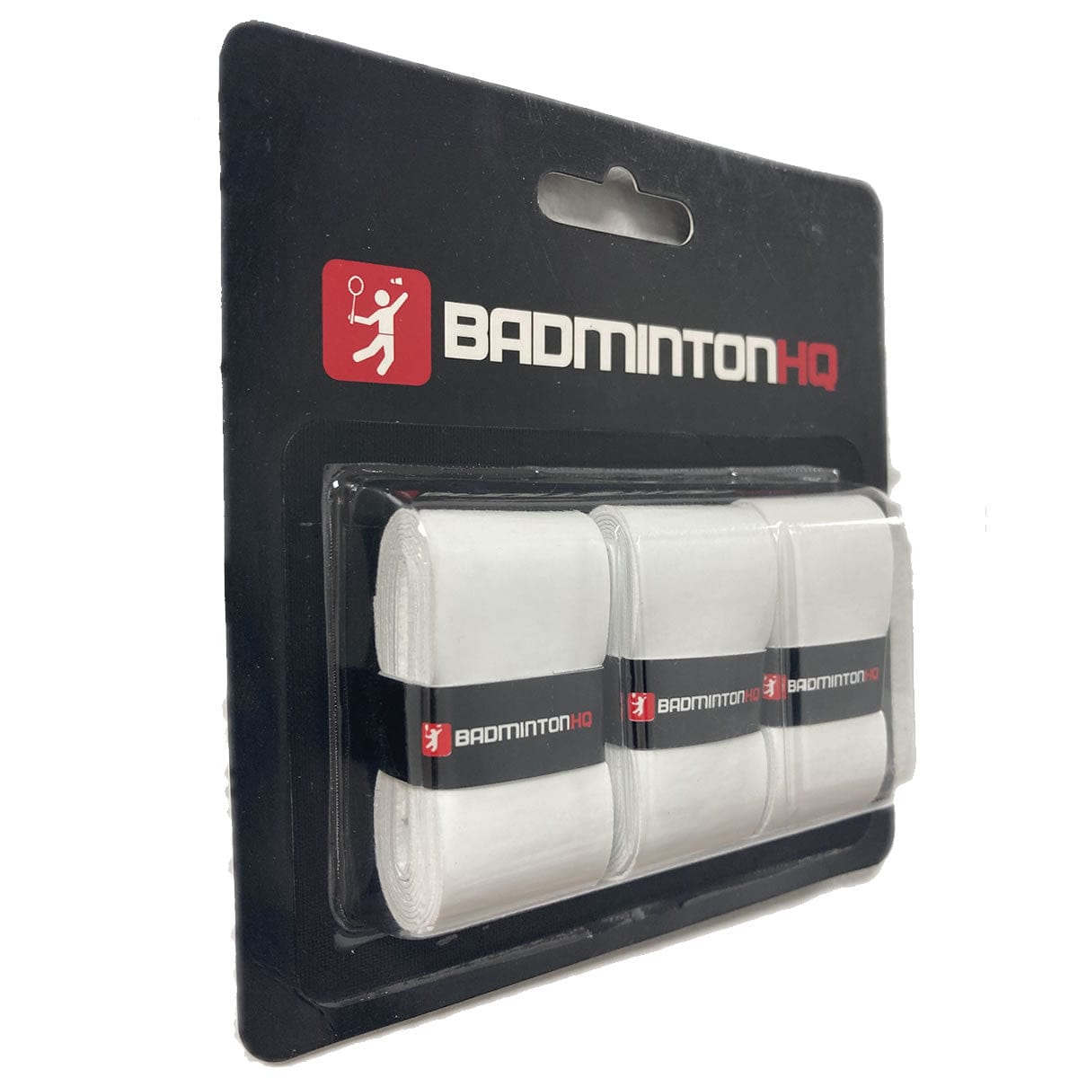 The BadmintonHQ 3 Pack Badminton Overgrips - White comes in transparent packaging with a sleek black cardboard backing, featuring exceptional grip consistency. The "BADMINTONHQ" logo and an icon of a player with a racket are prominently displayed.