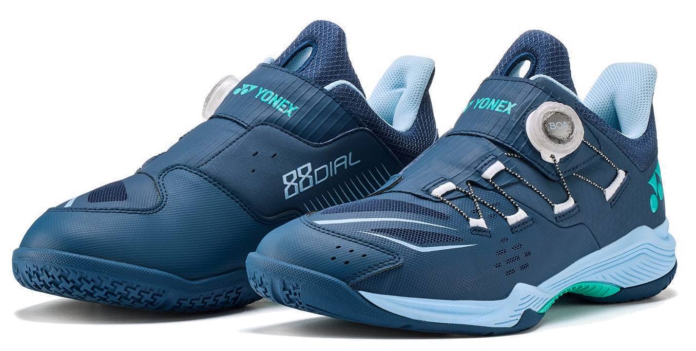 A pair of Yonex Power Cushion 88 Dial 3 Wide Unisex Badminton Shoes in navy and white, featuring the BOA Fit System dial closures and mesh details for enhanced breathability. Designed as a wide-fit shoe for durability and athletic performance on the badminton court, both shoes are shown angled outward.