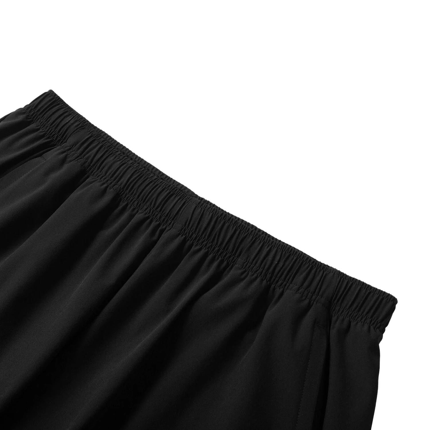 Close-up of Li-Ning Tournament Men's Badminton Shorts - Black, featuring an elastic waistband made with AT DRY technology for comfort and flexibility. The shorts, highlighted against a white background, epitomize high-performance badminton apparel from Li-Ning.