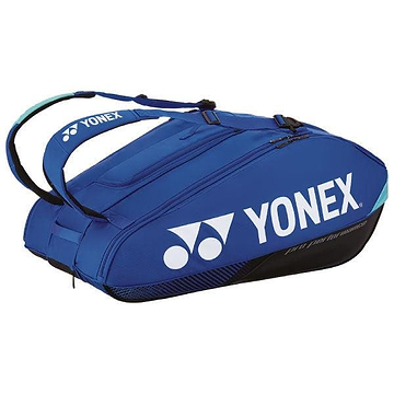 The Yonex 924212EX Pro 12 Racket Badminton Bag in Cobalt Blue, with its sleek and sporty design, prominently displays the iconic white Yonex logo. It includes thermo-guard compartments and has a capacity for 12 rackets, making it ideal for easily carrying all your tennis equipment.