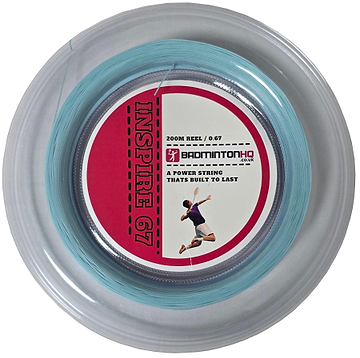 The clear round case of the BadmintonHQ Inspire 67 Zoom Light Blue badminton string (0.67mm, 200m) features a red label with a player's silhouette and the text "A power string that's built to last" from BADMINTONHQ.CO.UK. Crafted with durable nylon multifilament, it's perfect for racket stringing enthusiasts.