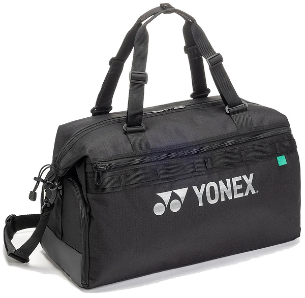 The Yonex BA72611EX Gearlogic Badminton Boston Bag in black is made from recycled polyester, with double handles, a detachable shoulder strap, zippered compartments, and a white Yonex logo on the side.
