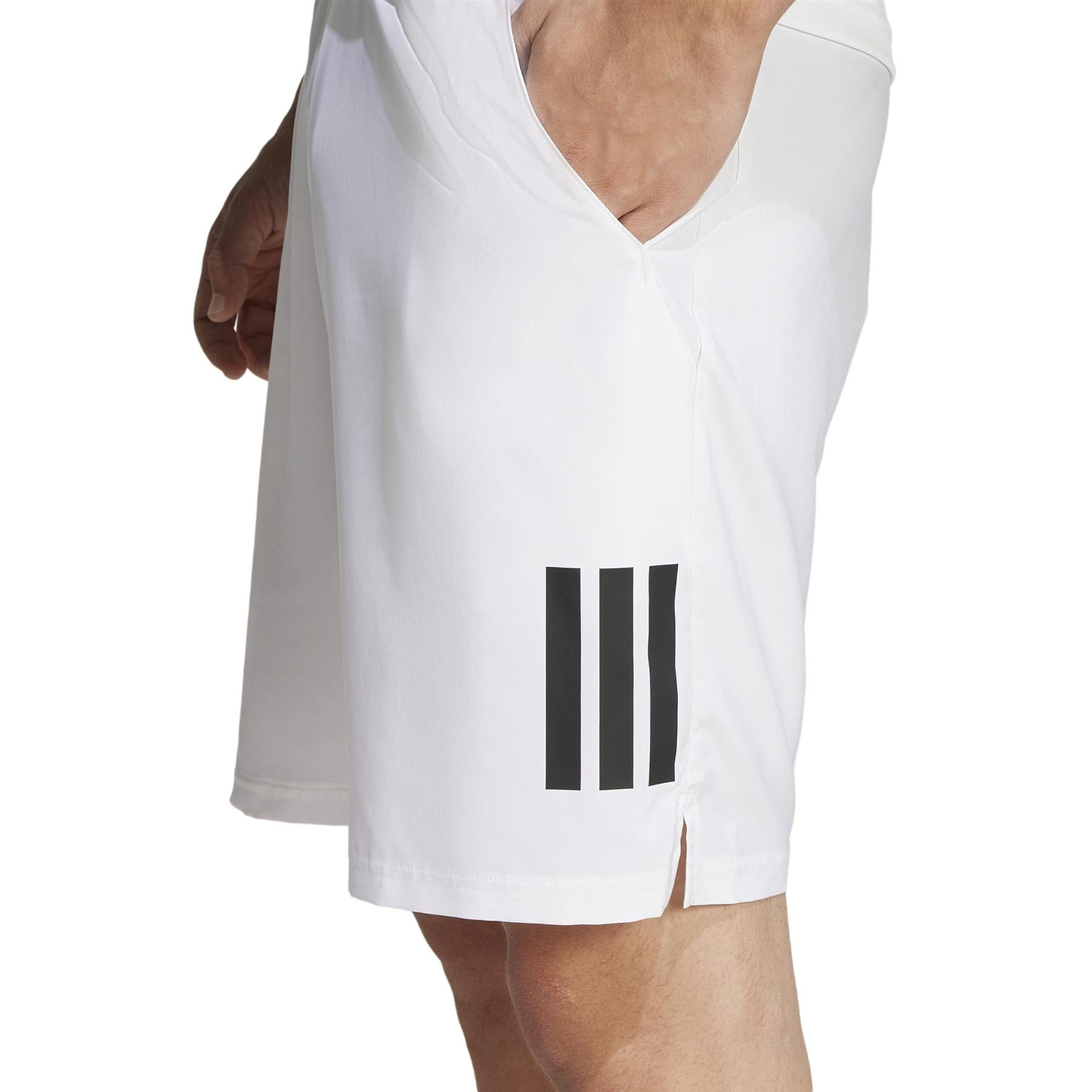 The image shows a side view of someone in a white athletic shirt with three vertical black stripes near the hem, styled like an ADIDAS Club shirt. The sleeveless, V-neck shirt pairs effortlessly with adidas Men's 3 Stripe Badminton Shorts - White, providing moisture-wicking comfort for intense play.
