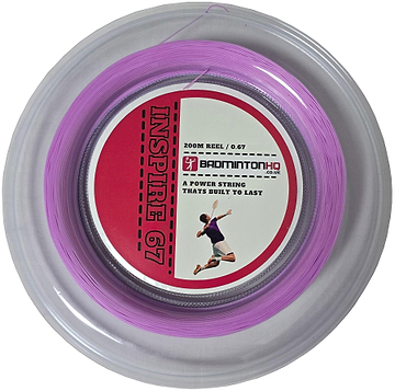 Close-up of a light pink, 0.67mm, 200m badminton string reel labeled "BadmintonHQ Inspire 67 Zoom Badminton String," in a circular plastic case with a red and white label featuring an action shot of a player.